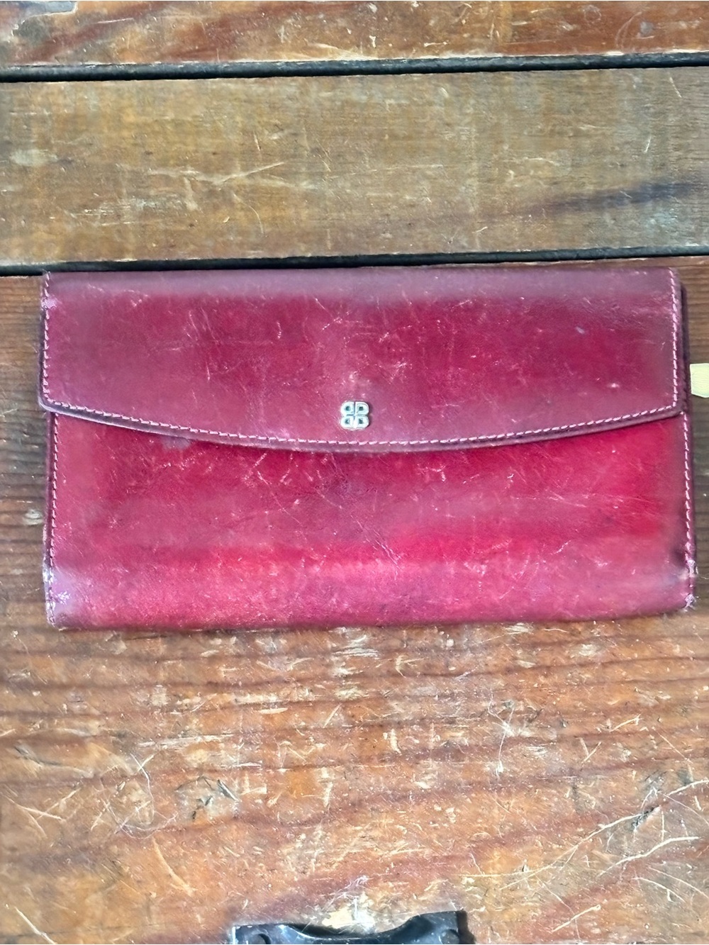Vintage Bosca burgundy full-grain leather foldover clutch wallet.